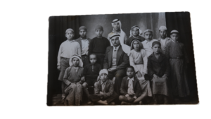 A Palestinian teacher and a group of boys at the Deir Amr Farm school and orphanage, 1942