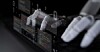 A robotic hand interacts with a code display, illustrating AI-assisted software development.