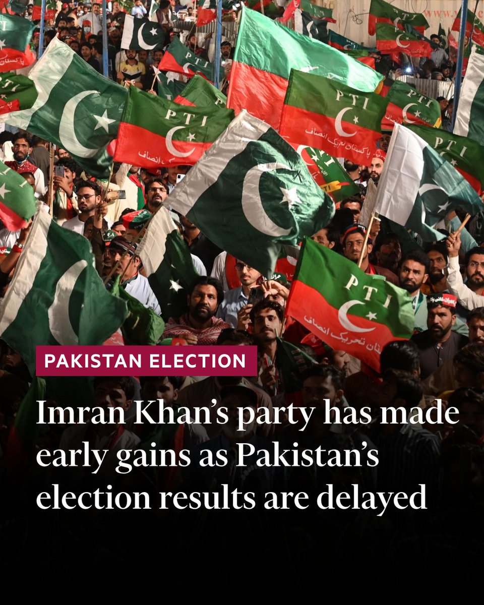 Supporters of Pakistan Tehreek-e-Insaf (PTI) party, of former Pakistan's prime minister Imran Khan, hold party and Pakistani flags as they listen to speech of the party leader during a rally in Lahore on April 21, 2022. (Photo by Arif ALI / AFP) (Photo by ARIF ALI/AFP via Getty Images). Text on image reads: 'Imran Khan's party has made early gains as Pakistan's election results are delayed'