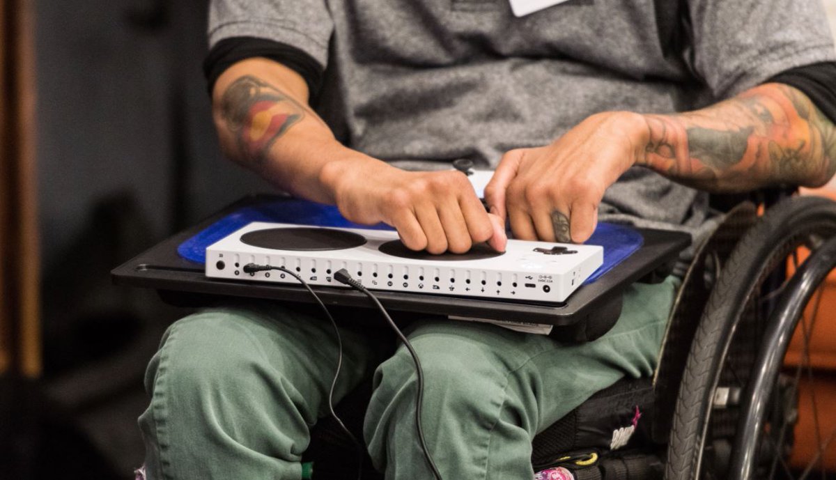 A man in a wheelchair uses the XBOX Adaptive Controller