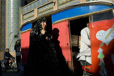 A woman walks in front of the Great Mosque in central Herat.
